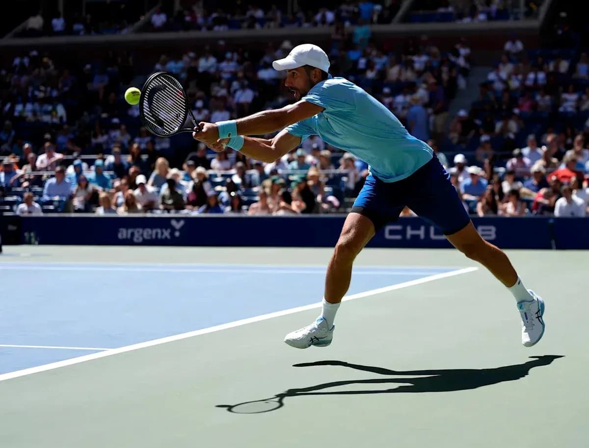Player reaching for a tennis ball during match