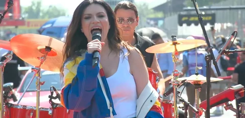 Singer performing on stage with band at event