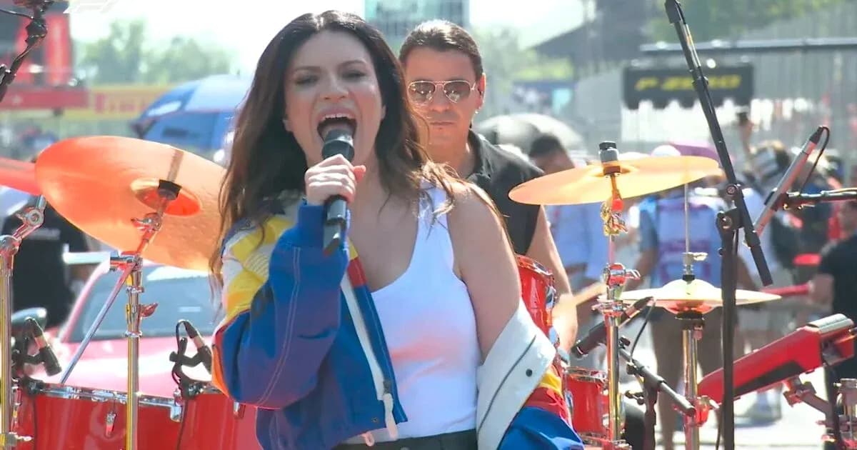 Singer performing on stage with band at event