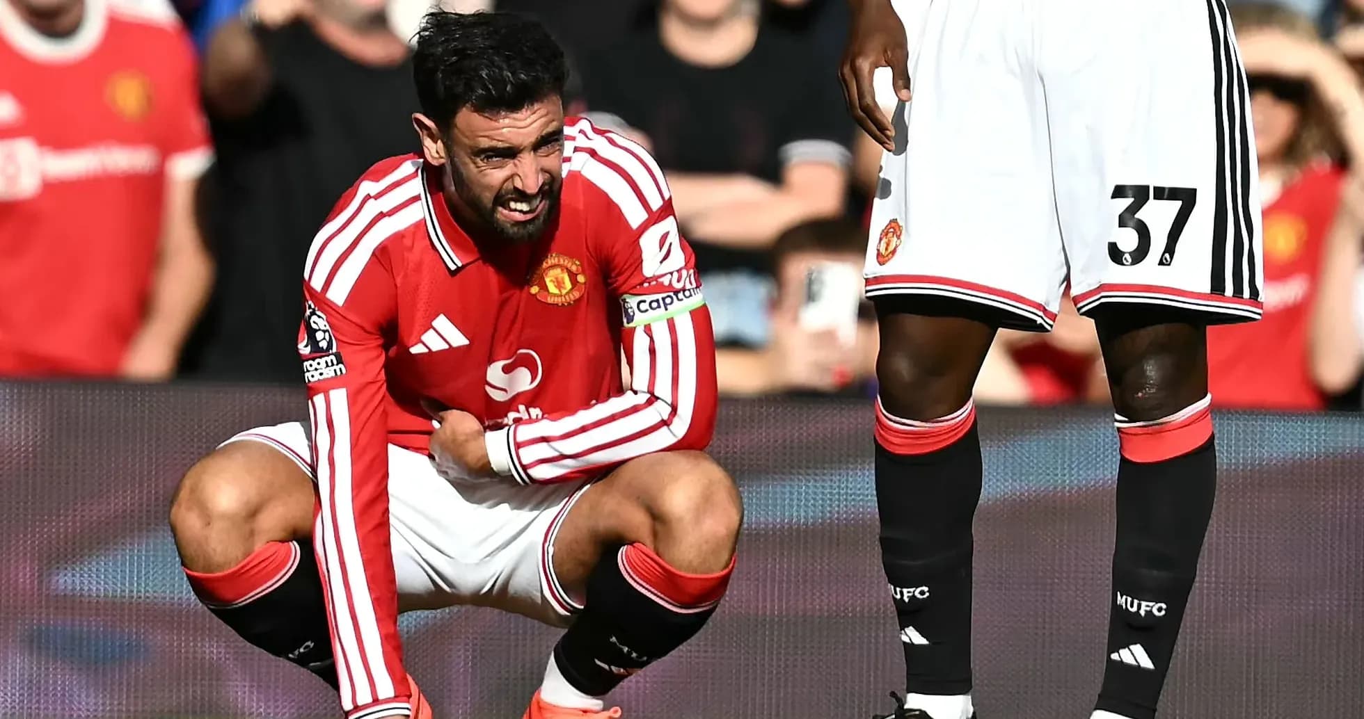 Bruno Fernandes crouching during a match injury
