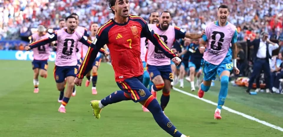 Spanish player celebrating goal with teammates in match