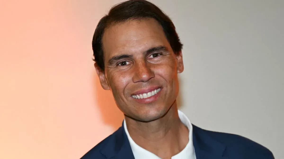 Smiling man in a suit against a light background