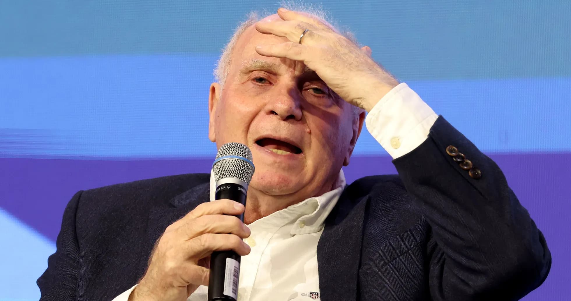 Speaker holding microphone during discussion event