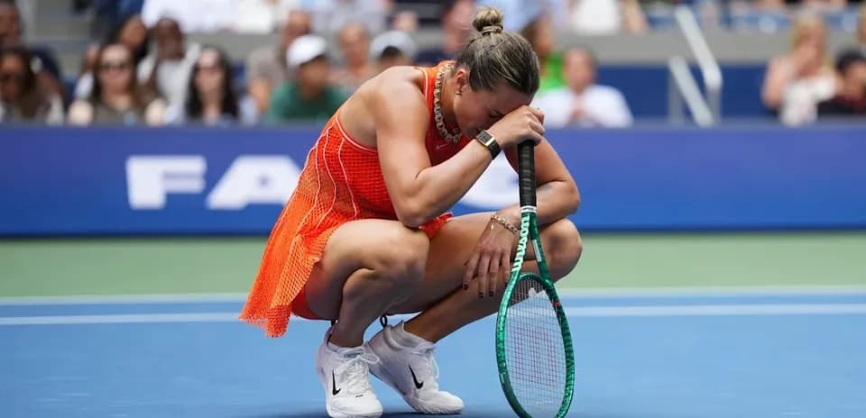 Player kneeling on court holding racket in distress