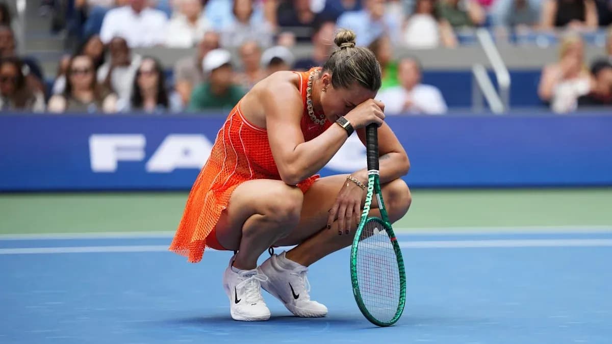 Player kneeling on court holding racket in distress