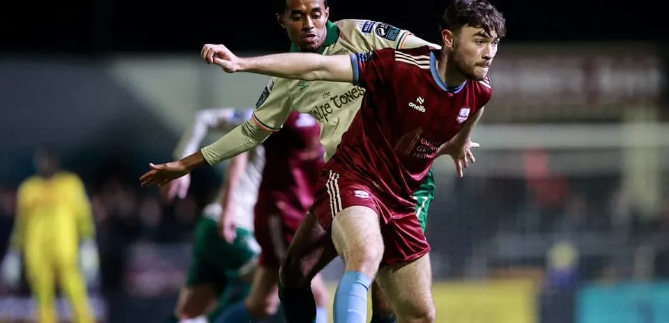 Two players contesting possession of the ball
