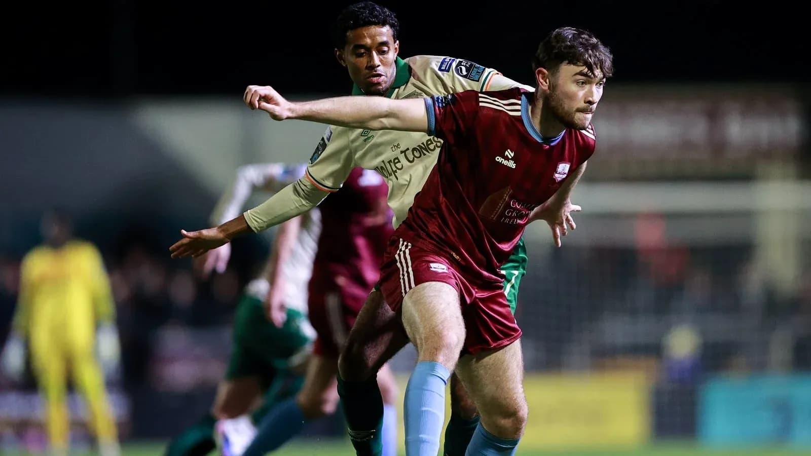 Two players contesting possession of the ball