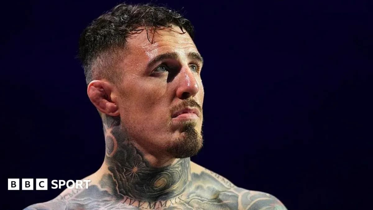Tattooed fighter looking up during match