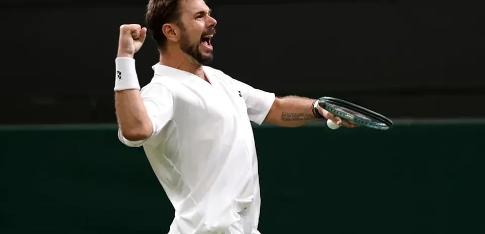 Tennis player celebrating victory with raised fist