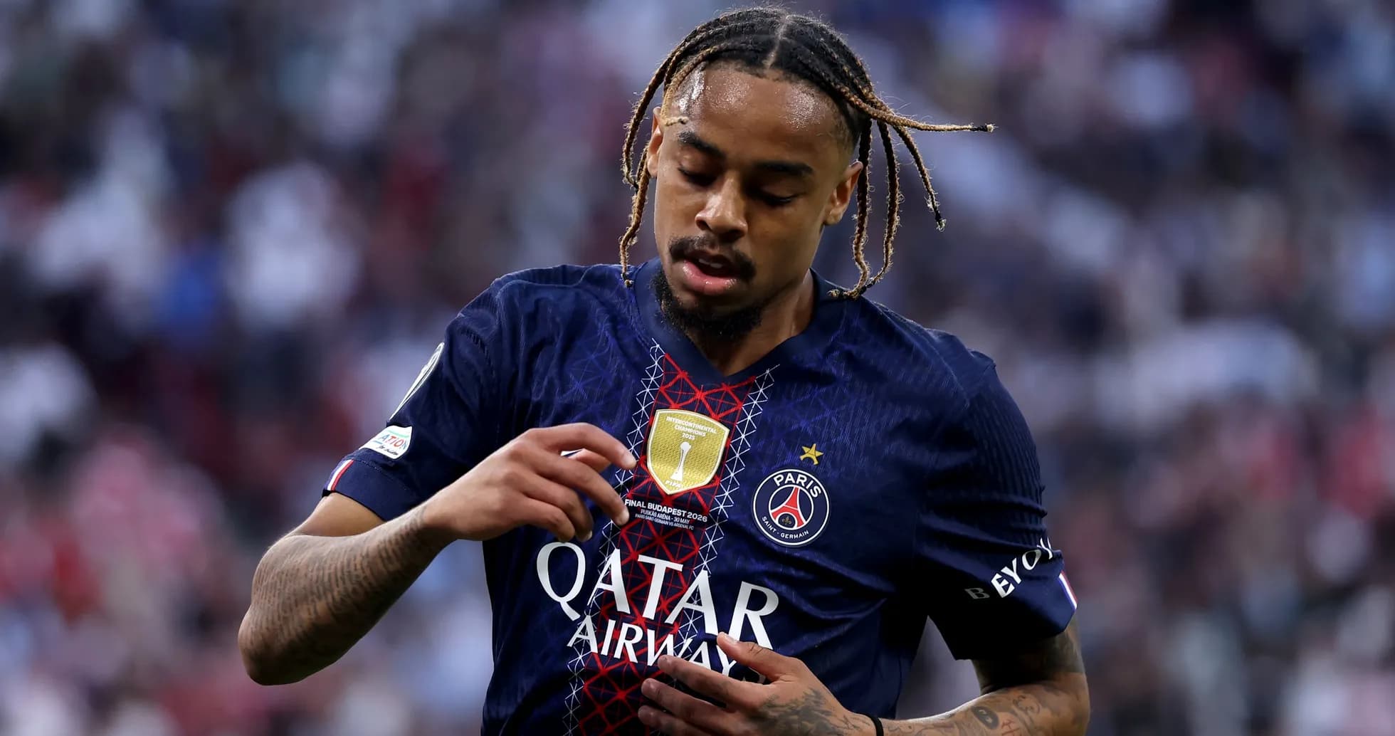 Player adjusting club badge on jersey during match
