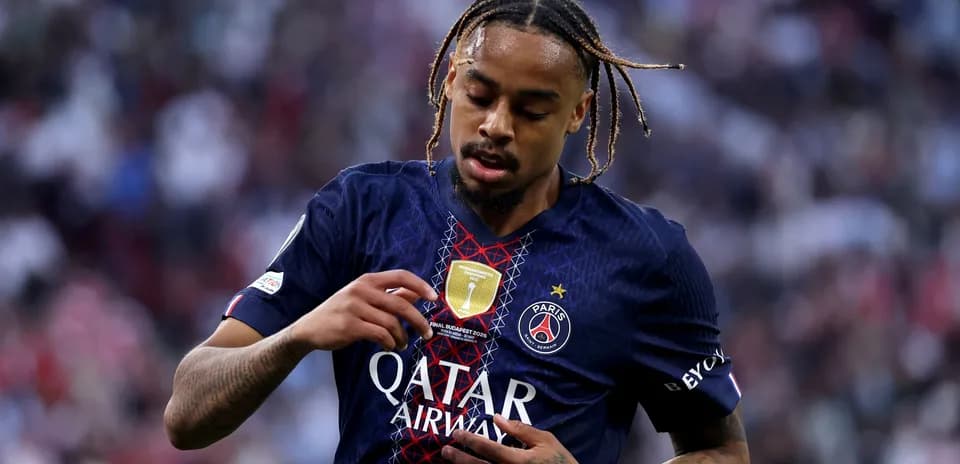 Player adjusting club badge on jersey during match