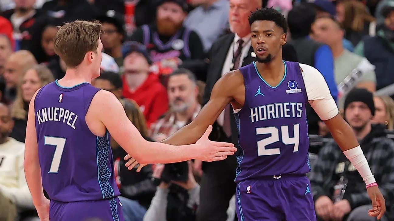 Two Hornets players exchanging handshakes during game