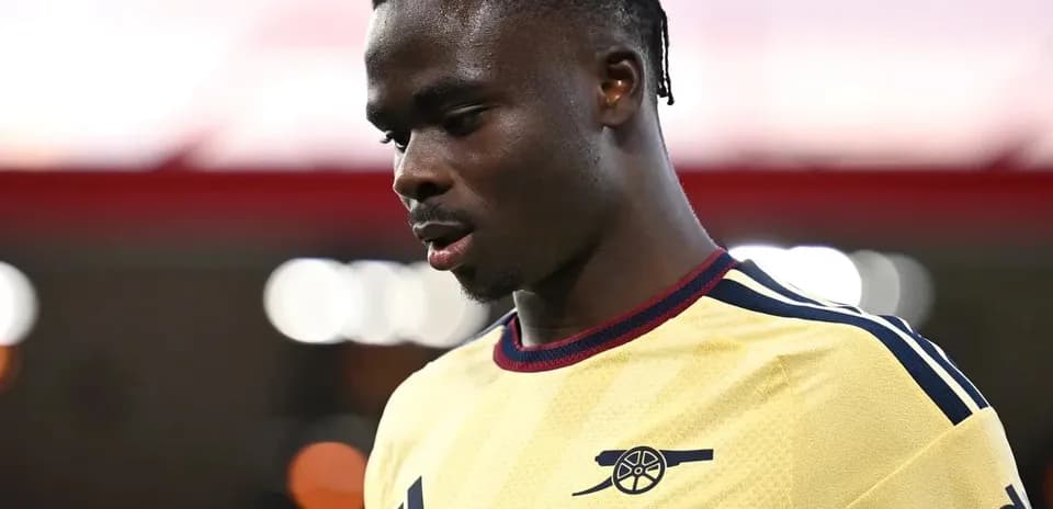 Player in Arsenal kit looking down during match