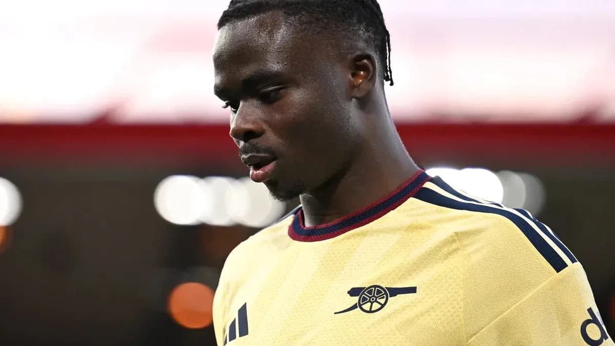 Player in Arsenal kit looking down during match