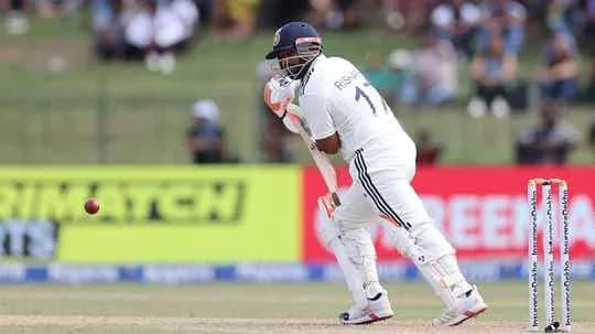 Batsman defending against a delivery in cricket match