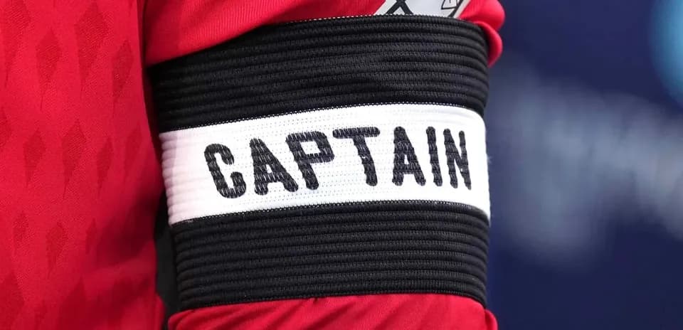 Close-up of a captain's armband with 'CAPTAIN'
