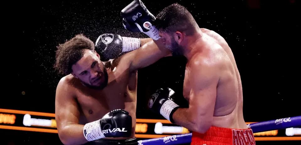 Two boxers exchanging punches in the ring