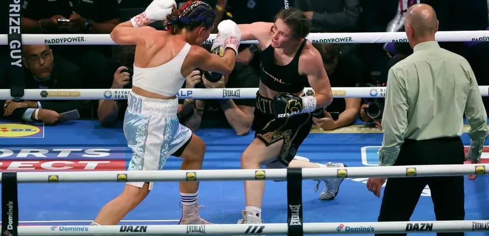 Two female boxers exchanging punches in the ring