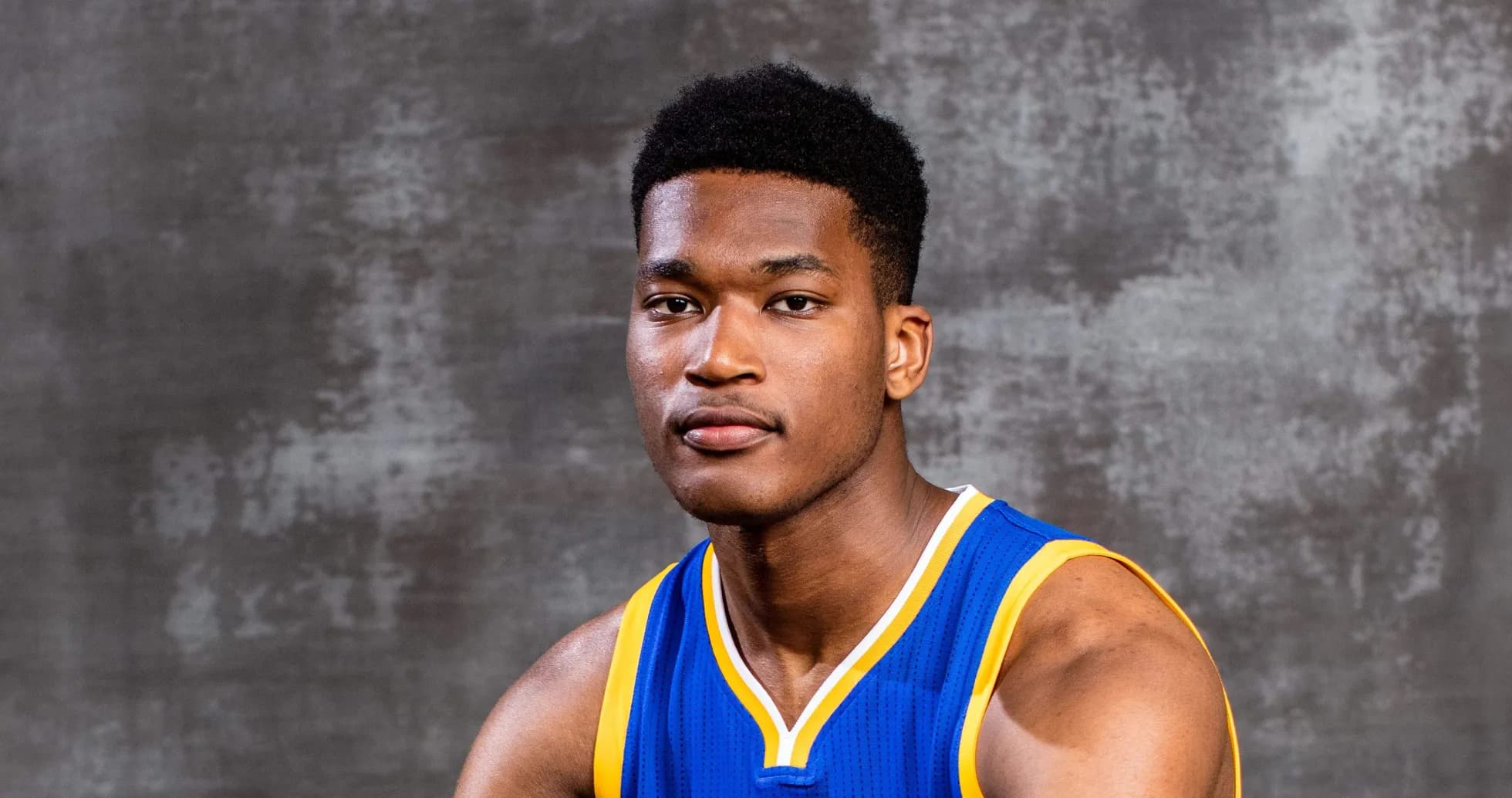Basketball player in team jersey posing for photo