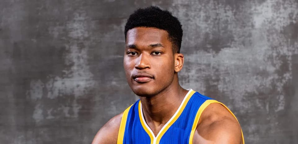 Basketball player in team jersey posing for photo