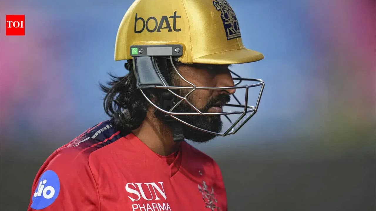 Cricketer wearing a golden helmet during match