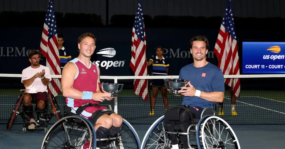 Two wheelchair tennis players holding trophies at US Open