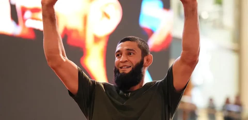 Fighter celebrating with raised arms in event venue