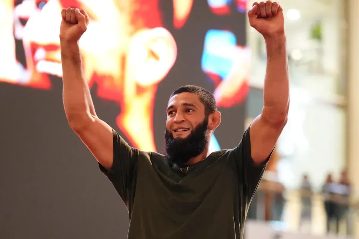 Fighter celebrating with raised arms in event venue