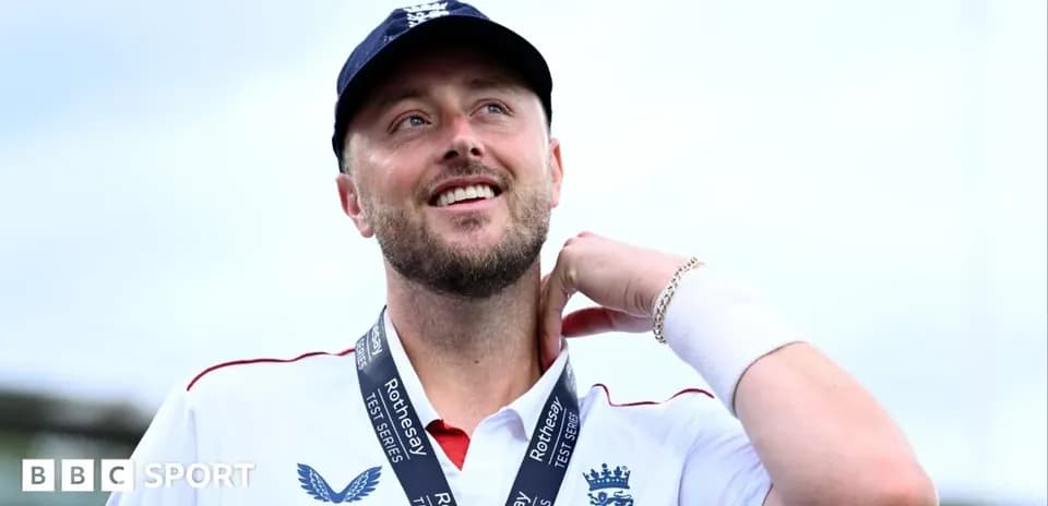 Cricketer wearing medal and smiling after match