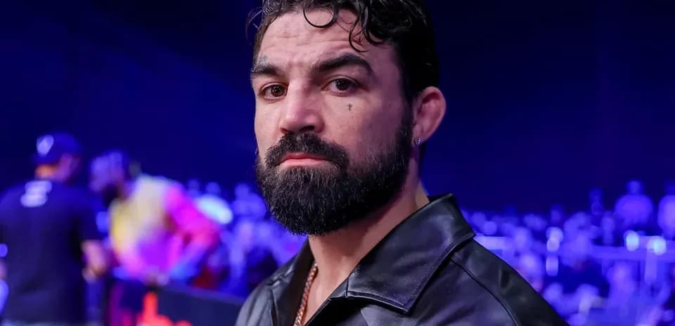Man with beard and leather jacket at event