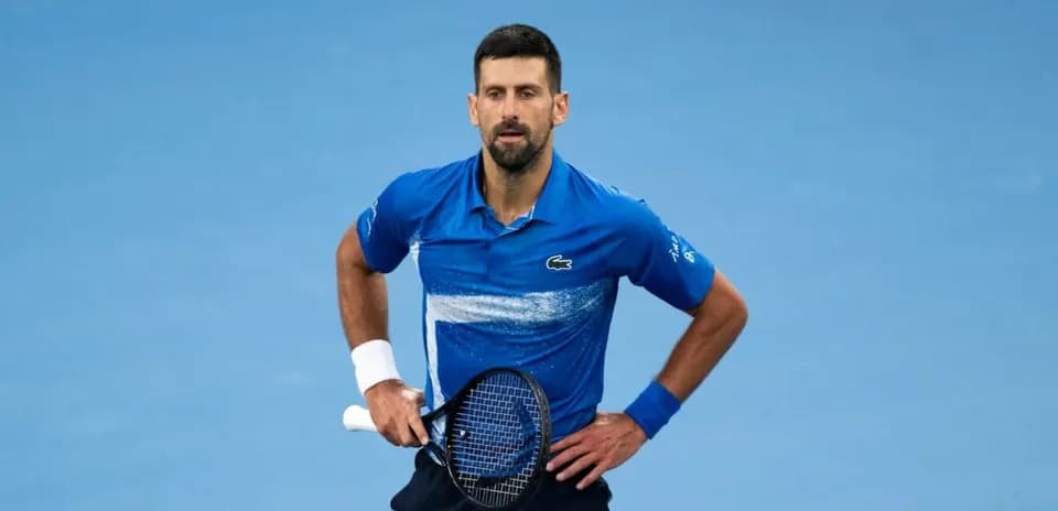 Tennis player in blue shirt on court