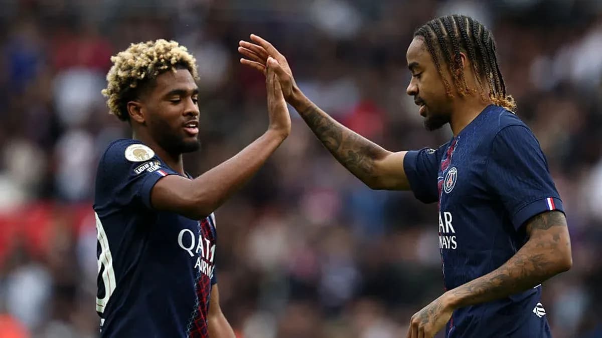 Two PSG players high-fiving during a match