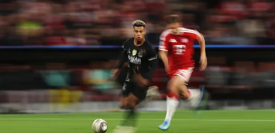 Player dribbling the ball with opponent chasing