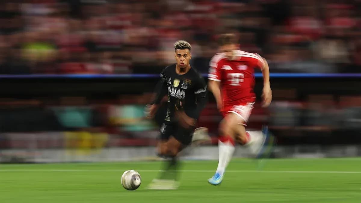 Player dribbling the ball with opponent chasing