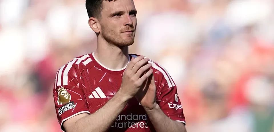Player clapping in red jersey at stadium
