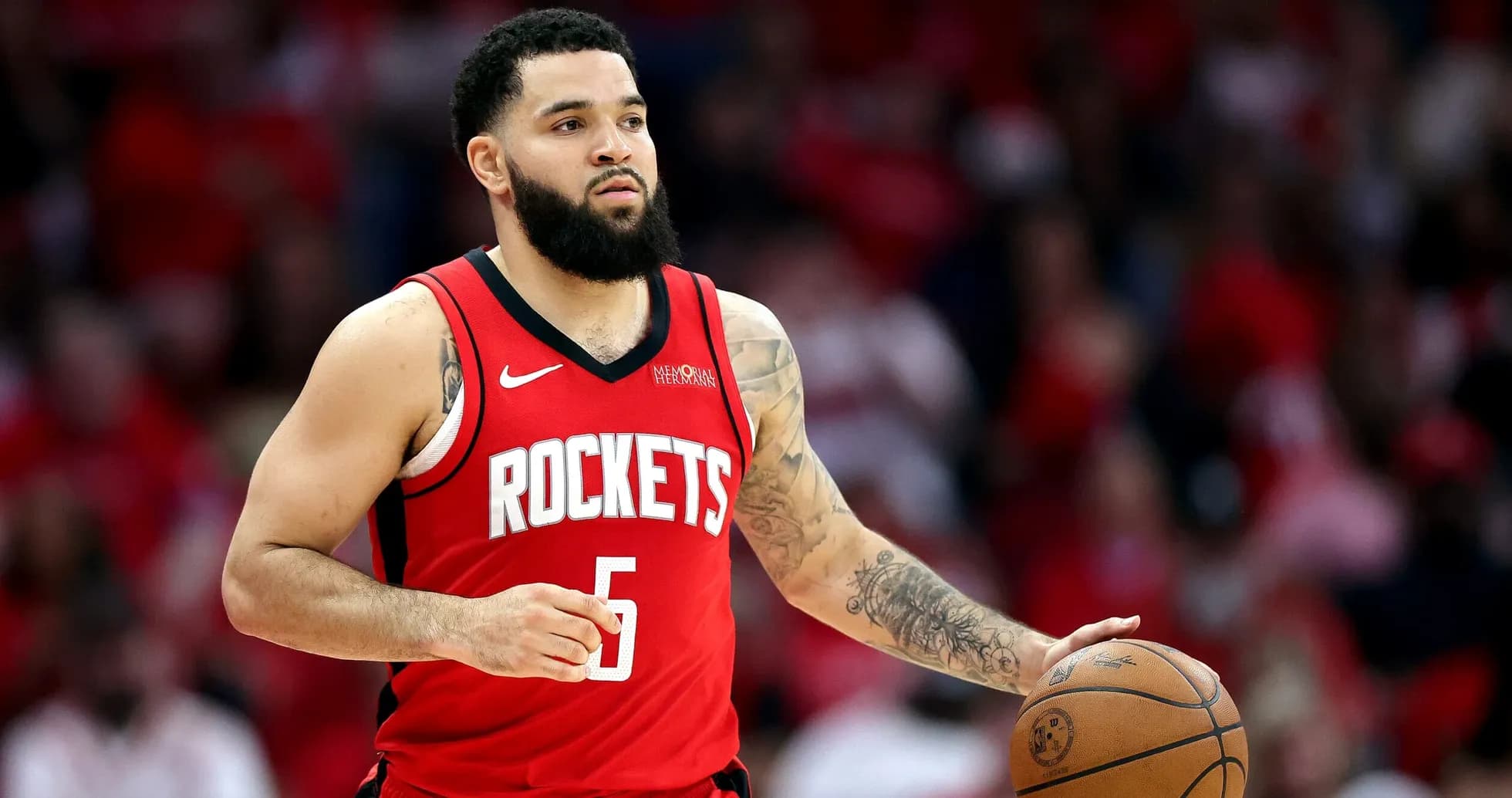 Player dribbling basketball during game for Rockets