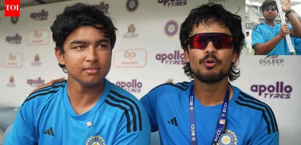 Two cricket players in blue jerseys during interview