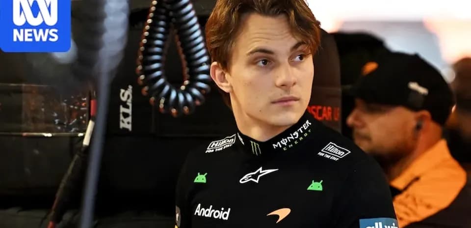 Driver in McLaren suit in pit area