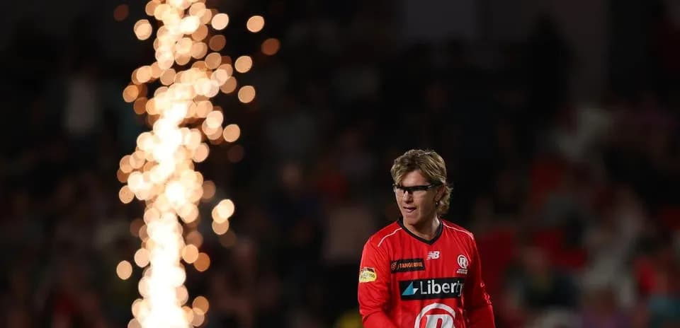 Player in red uniform during match with fireworks