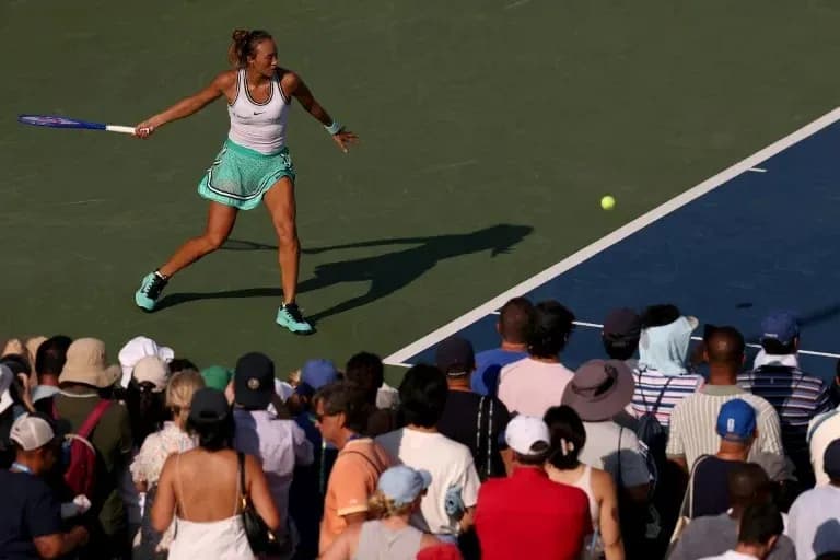 Tennis player hitting a forehand shot during match