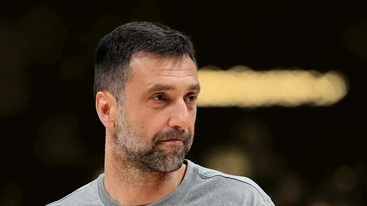 Man with short hair and beard in sports attire