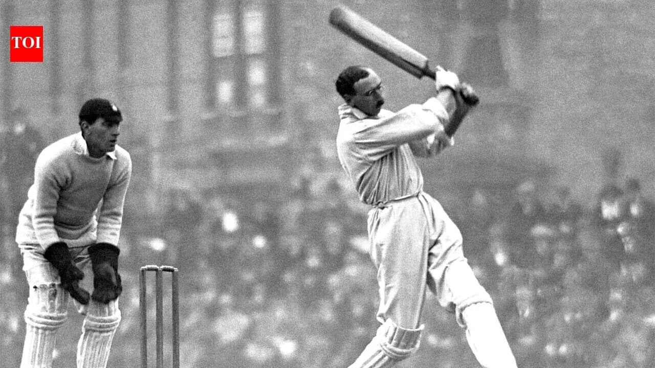 Batsman striking ball with bat, wicketkeeper behind