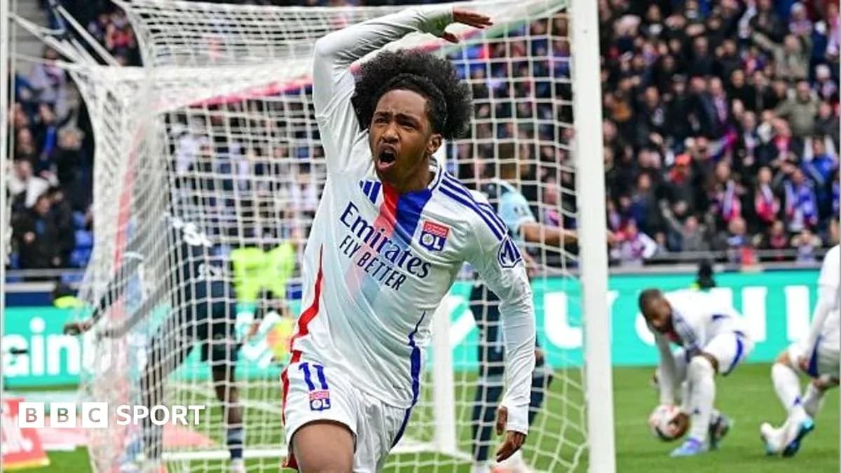 Player celebrating a goal in stadium with crowd