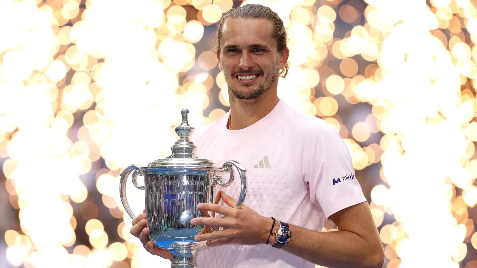 Player holding trophy with sparkling background