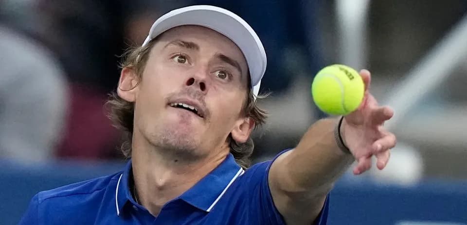 Player serving tennis ball during match