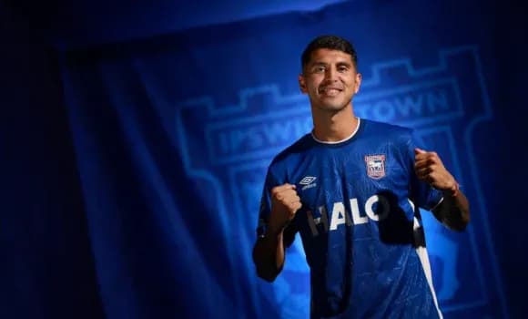 Player in Ipswich Town jersey posing for photo