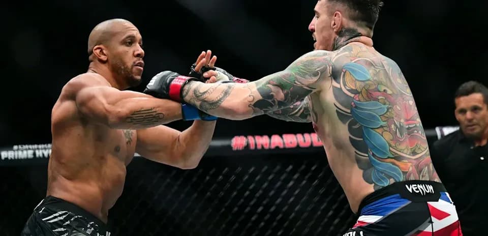Two fighters exchanging punches in octagon match