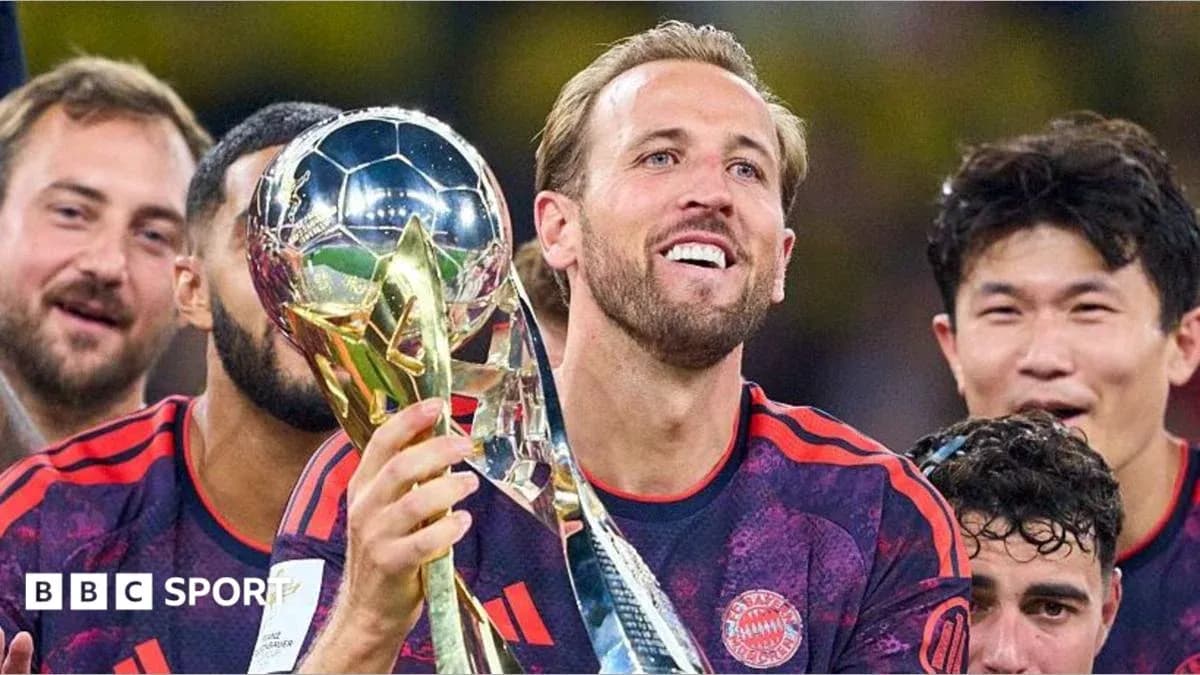 Player celebrating with trophy surrounded by teammates