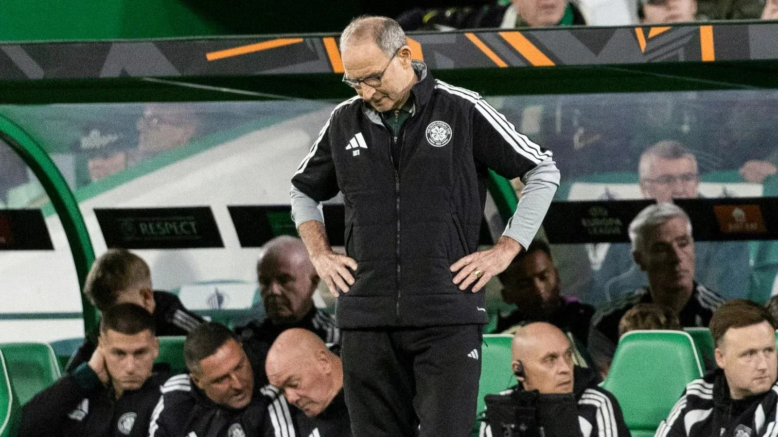 Manager with head down on team bench during match
