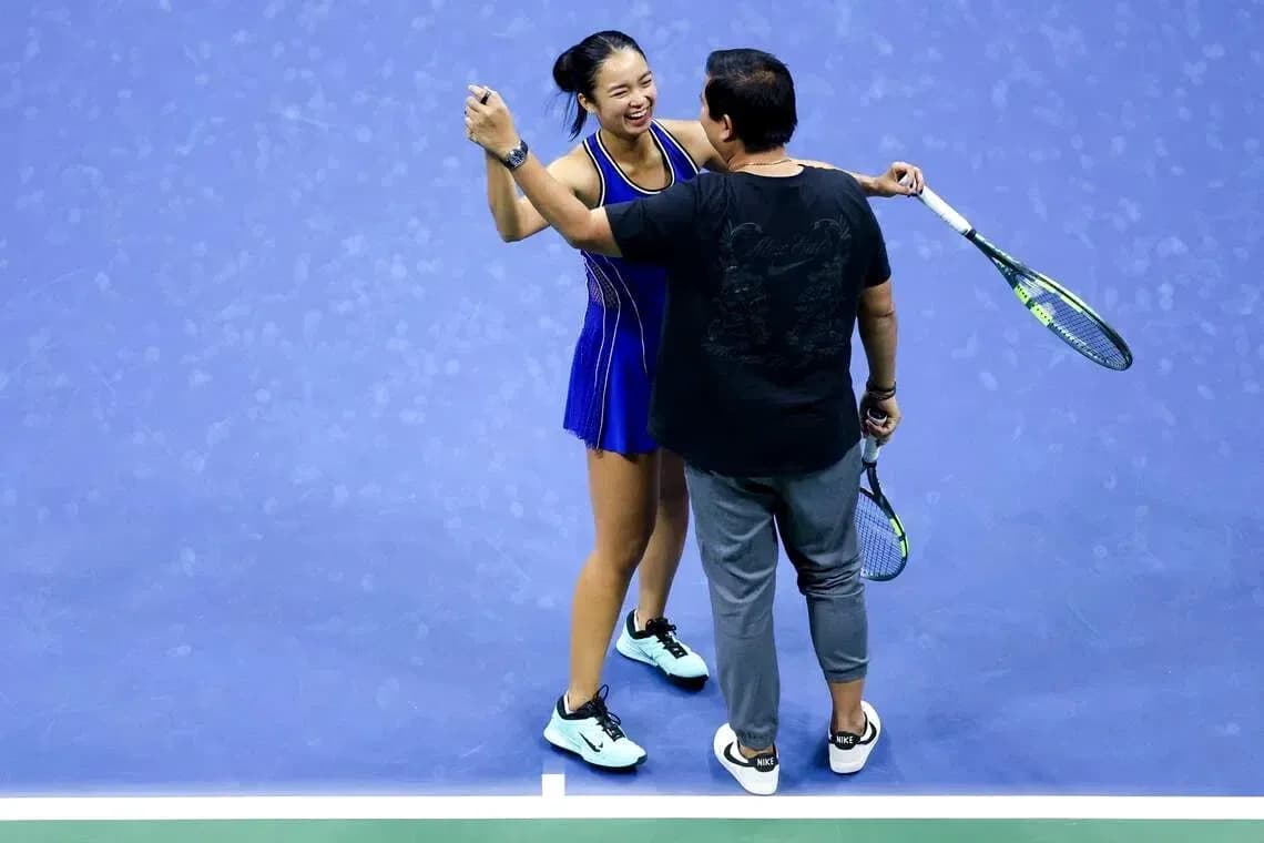 Player celebrating with coach on tennis court